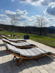a row of beds sitting on top of a patio at Holiday Home Zagorka in Ogulin