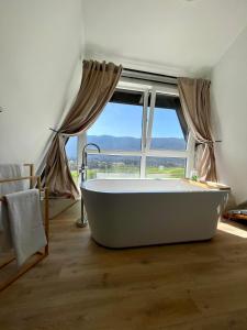 a large bath tub in a room with a window at Holiday Home Zagorka in Ogulin