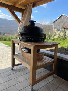 a wooden table with a stove on top of it at Holiday Home Zagorka in Ogulin