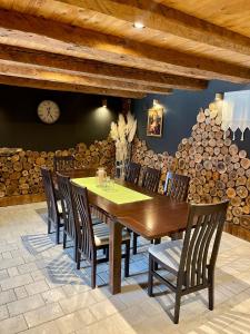a dining room with a wooden table and chairs at Holiday Home Zagorka in Ogulin