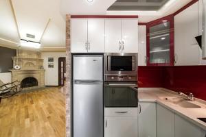 a kitchen with white cabinets and a refrigerator at 2-BDR/Perfect Location/Cozy in Yerevan