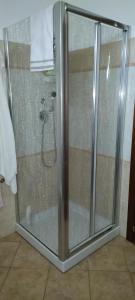 a shower with a glass door in a bathroom at Taverna Cristina in Porto Torres