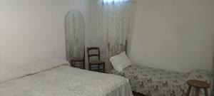 a room with two beds and a couch and chairs at Taverna Cristina in Porto Torres
