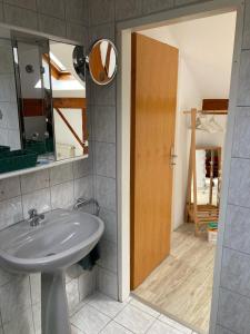 ein Bad mit einem Waschbecken und einem Spiegel in der Unterkunft NaturPur in Monschau