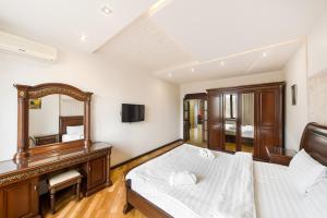 a bedroom with a bed and a mirror at 2-BDR/Perfect Location/Cozy in Yerevan