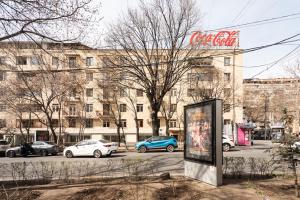 a sign in front of a building with parked cars at 2-BDR/Perfect Location/Cozy in Yerevan