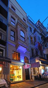 a building on a street at night with a store at Taksim Estane Butik Otel in Istanbul