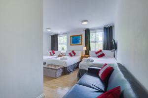 a living room with two beds and a couch at Lamont Hotel in London