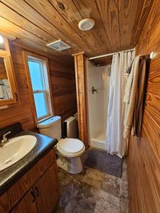 a wooden bathroom with a toilet and a sink at Wheeler Lake Riverbend Haven 2 in Stilwell