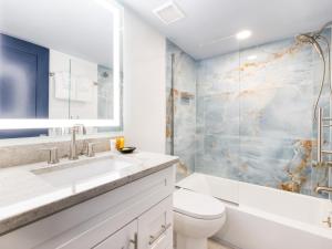 a bathroom with a sink and a toilet and a shower at South Seas Resort in Captiva