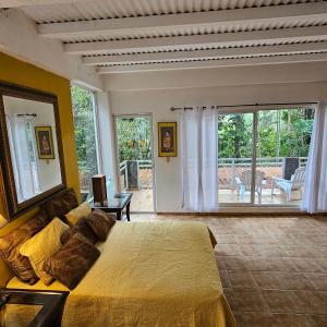 a bedroom with a large bed and a balcony at OLP Treehouse Cerro Azul in Cerro Azul