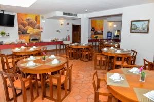 a dining room with wooden tables and chairs at LagosMar Story Hotel in Lagos