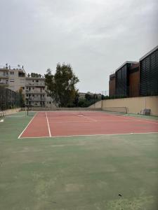 a tennis court with two tennis courts at Cosy Flat Cannes in Le Cannet