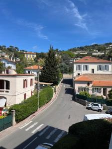 a view of a street with houses and a car at Cosy Flat Cannes in Le Cannet