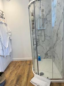 a shower with a glass enclosure in a bathroom at The Old Dairy in Newbury