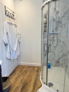 a bathroom with a shower with a glass shower stall at The Old Dairy in Newbury