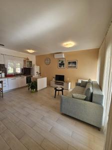 a living room with a couch and a kitchen at Apartment Marija in Sali