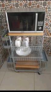 a microwave oven sitting on top of a shelf at Résidence privée in Conakry