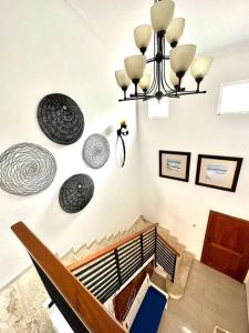 a room with a staircase with plates on the wall at Amplia Villa en Metro Country Club in La Puntica de Juan Dolio