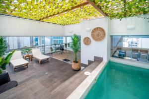 a house with a swimming pool with a ceiling at Luxury Ocean View Penthouse with Pool in Miraflores in Lima