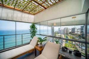 a room with a view of the ocean at Luxury Ocean View Penthouse with Pool in Miraflores in Lima