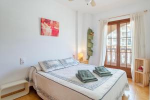 a bedroom with a bed with two pillows on it at Playa Arenales del Sol in Arenales del Sol +20 photos