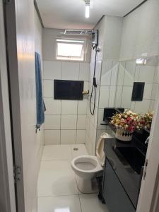 a small bathroom with a toilet and a sink at ALUGUEL TEMPORADA TECNOSHOW in Rio Verde