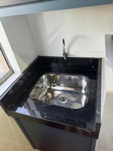 a stainless steel sink in a small kitchen at ALUGUEL TEMPORADA TECNOSHOW in Rio Verde