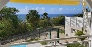 a view of the ocean from the balcony of a house at Villa Blue Marine in Deshaies +8 photos