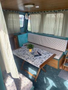 a table and bench in the back of an rv at Stahlschiff DORINA in Sassnitz