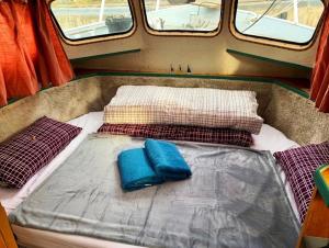 a bed in an rv with two pillows on it at Stahlschiff DORINA in Sassnitz