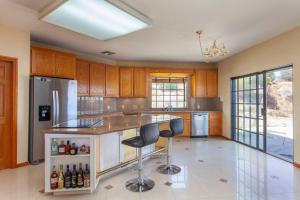 a large kitchen with a island with bar stools at LUXURIOUS VILLA FOR BEST VACATIONS AND MEMORIES in Palmdale