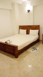 uma cama num quarto com um telefone em Sobasee Deluxe Bungalow em Kandy