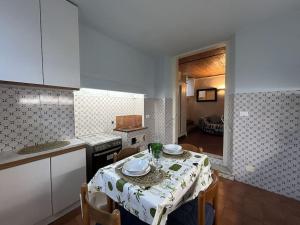 a kitchen with a table with a table cloth on it at Residenza Storica in Villa Palazzo Bruciato in Florence