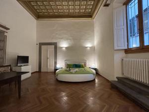 a bedroom with a large bed in a room at Residenza Storica in Villa Palazzo Bruciato in Florence