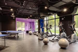 a gym with ping pong tables and exercise equipment at Chillout Dorm Warszawa by BookingHost in Warsaw