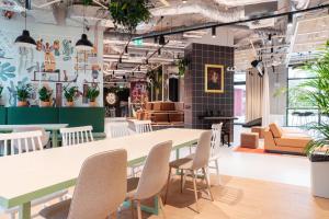 a table and chairs in a room with plants at Chillout Dorm Warszawa by BookingHost in Warsaw