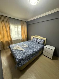 a bedroom with a bed and a window at URAZ Suit Otel in Bursa