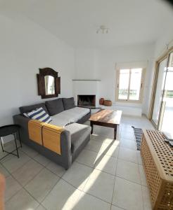 a living room with a couch and a table at Villa Enalia Paphos in Paphos City