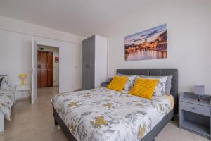 a bedroom with a large bed with yellow pillows at San Pietro Dream House in Rome
