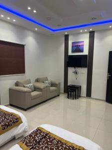 a living room with a couch and a bed at Dar Al Karama Residential Units in AlUla