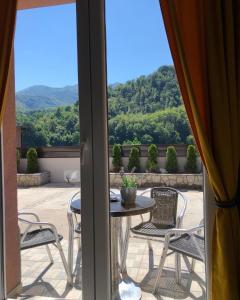 a view of a patio with a table and chairs at Aphrodite Hills Apartments-Stara Planina in Crni Vrh