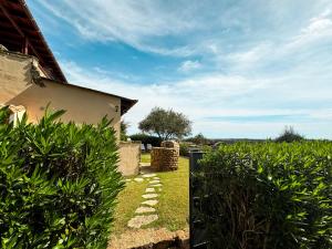 a view of a yard with bushes and a house at Villa Erika Is Molas mare golf in Pula