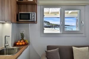 a kitchen with a window with a view of a beach at Villa Thalassa in Milatos