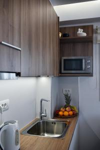 a kitchen with a sink and a bowl of fruit at Villa Thalassa in Milatos