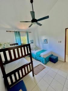a bedroom with a bed and a ceiling fan at Villa Grupal en Metro Country Club. in La Fe