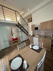 a kitchen with a table and chairs and a staircase at Amore e Psiche in Scilla