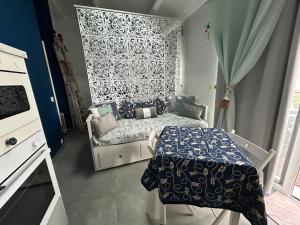a small bedroom with a bed and a table at Studio bord de mer 1 lit double 1 lit simple in Hyères
