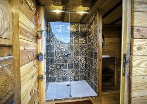 a bathroom with a window and a bath tub at La yourte kirghize in Alès