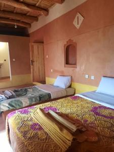 a room with two beds in a room at Gorges View Dades in Tamellalt